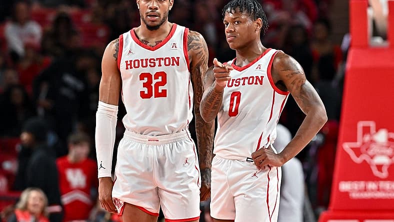 Nov 16, 2022; Houston, Texas, USA; Houston Cougars guard Marcus Sasser (0) and forward Reggie Chaney (32) stand on the court during the first half against the Texas Southern Tigers at Fertitta Center. Mandatory Credit: Maria Lysaker-USA TODAY Sports