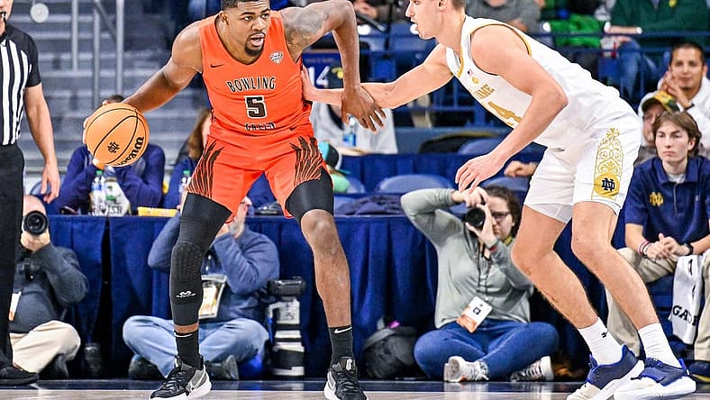 Nov 22, 2022; South Bend, Indiana, USA; Bowling Green Falcons forward Rashaun Agee (5) dribbles as Notre Dame Fighting Irish forward Nate Laszewski (14) defends in the first half at the Purcell Pavilion. Mandatory Credit: Matt Cashore-USA TODAY Sports