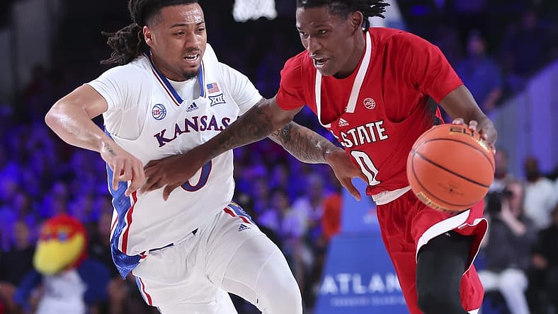 Nov 23, 2022; Paradise Island, BAHAMAS; North Carolina State Wolfpack guard Terquavion Smith (0) drives to the basket as Kansas Jayhawks guard Bobby Pettiford Jr. (0) defends during the second half at Imperial Arena. Mandatory Credit: Kevin Jairaj-USA TODAY Sports
