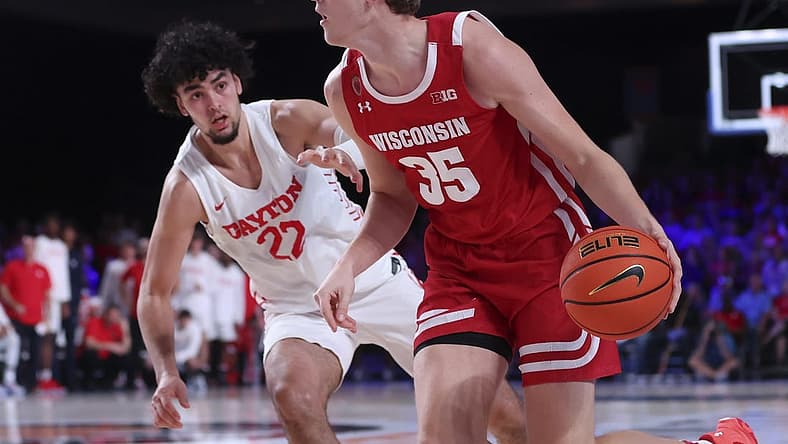 Nov 23, 2022; Paradise Island, BAHAMAS; Wisconsin Badgers forward Markus Ilver (35) dribbles as Dayton Flyers forward Mustapha Amzil (22) defends during the second half at Imperial Arena. Mandatory Credit: Kevin Jairaj-USA TODAY Sports