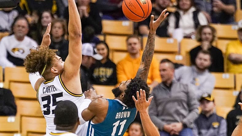 Nov 23, 2022; Columbia, Missouri, USA; Coastal Carolina Chanticleers guard Jomaru Brown (11) shoots a layup as Missouri Tigers forward Noah Carter (35) defends during the first half at Mizzou Arena. Mandatory Credit: Denny Medley-USA TODAY Sports