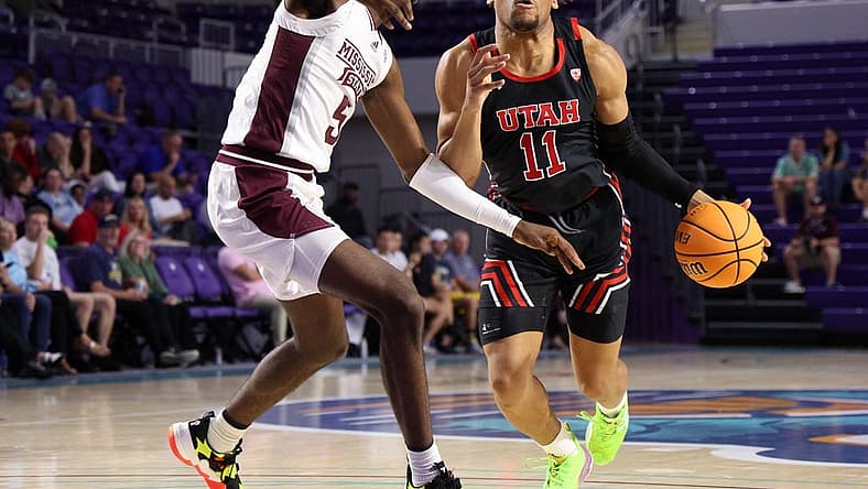 Nov 23, 2022; Fort Myers, Florida, USA; Utah Utes guard Wilguens Exacte Jr. (11) drives to the hoop past Mississippi State Bulldogs forward Kimani Hamilton (5) in the first half during the Fort Myers Tip-Off Beach Division championship game at Suncoast Credit Union Arena. Mandatory Credit: Nathan Ray Seebeck-USA TODAY Sports