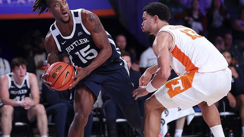 Nov 23, 2022; Paradise Island, BAHAMAS; Butler Bulldogs center Manny Bates (15) looks to pass as Tennessee Volunteers forward Olivier Nkamhoua (13) defends during the second half at Imperial Arena. Mandatory Credit: Kevin Jairaj-USA TODAY Sports