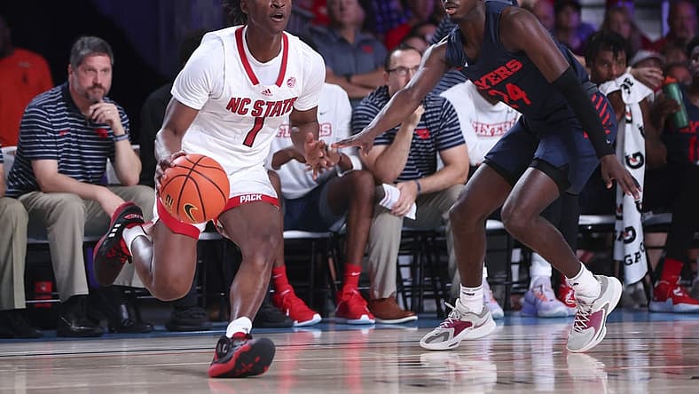 Nov 24, 2022; Paradise Island, BAHAMAS; North Carolina State Wolfpack guard Jarkel Joiner (1) looks to shoot as Dayton Flyers guard Kobe Elvis (24) defends during the first half at Imperial Arena. Mandatory Credit: Kevin Jairaj-USA TODAY Sports
