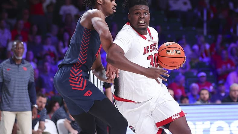 Nov 24, 2022; Paradise Island, BAHAMAS; North Carolina State Wolfpack forward D.J. Burns Jr. (30) drives to the basket as Dayton Flyers forward DaRon Holmes II (15) defends during the first half at Imperial Arena. Mandatory Credit: Kevin Jairaj-USA TODAY Sports
