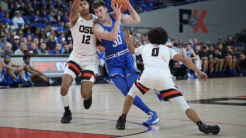 Nov 24, 2022; Portland, Oregon, USA; Duke Blue Devils center Kyle Filipowski (30) drives to the basket during the first half against Oregon State Beavers forward Michael Rataj (12) and guard Jordan Pope (0) at Veterans Memorial Coliseum. Mandatory Credit: Troy Wayrynen-USA TODAY Sports