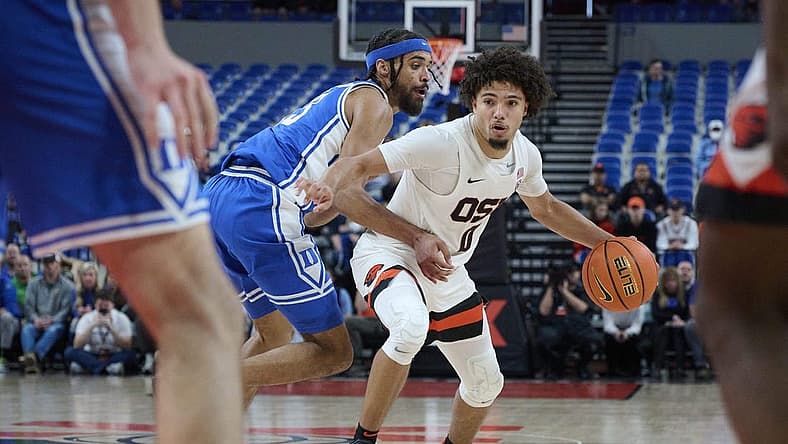 Nov 24, 2022; Portland, Oregon, USA; Oregon State Beavers guard Jordan Pope (0) drives to the basket during the second half against Duke Blue Devils guard Jacob Grandison (13) at Veterans Memorial Coliseum. Duke won the game 54-51. Mandatory Credit: Troy Wayrynen-USA TODAY Sports