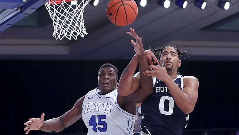 Nov 24, 2022; Paradise Island, BAHAMAS; Brigham Young Cougars forward Fousseyni Traore (45) and Butler Bulldogs forward D.J. Hughes (0) fight for a loose ball during the first half at Imperial Arena. Mandatory Credit: Kevin Jairaj-USA TODAY Sports