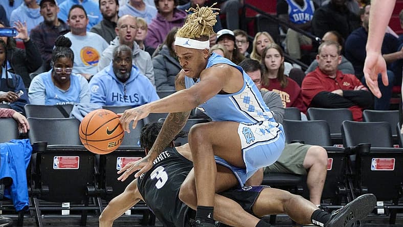 Nov 24, 2022; Portland, Oregon, USA; North Carolina Tar Heels forward Armando Bacot (5) and Portland Pilots forward Alden Applewhite (3) scramble for the ball during the second half at Moda Center. North Carolina won the game 89-81. Mandatory Credit: Troy Wayrynen-USA TODAY Sports