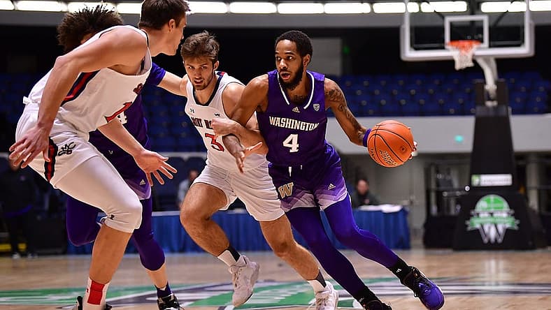 Nov 24, 2022; Anaheim, California, USA; Washington Huskies guard PJ Fuller II (4) moves the ball against St. Mary's Gaels guard Augustas Marciulionis (3) and center Mitchell Saxen (11) during the first half at Anaheim Convention Center. Mandatory Credit: Gary A. Vasquez-USA TODAY Sports