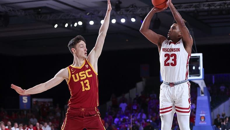 Nov 25, 2022; Paradise Island, BAHAMAS; Wisconsin Badgers guard Chucky Hepburn (23) shoots over USC Trojans guard Drew Peterson (13) during the first half at Imperial Arena. Mandatory Credit: Kevin Jairaj-USA TODAY Sports