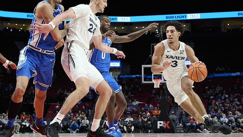 Nov 25, 2022; Portland, Oregon, USA; Xavier Musketeers guard Colby Jones (3) drives to the basket during the first half with help from teammate forward Jack Nunge (24) against Duke Blue Devils forward Dariq Whitehead (0) and center Dereck Lively II (1) at Moda Center. Mandatory Credit: Troy Wayrynen-USA TODAY Sports