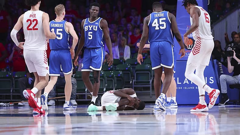Nov 25, 2022; Paradise Island, BAHAMAS; Dayton Flyers guard Kobe Elvis (24) lays injured on the floor during the second half against the Brigham Young Cougars at Imperial Arena. Mandatory Credit: Kevin Jairaj-USA TODAY Sports