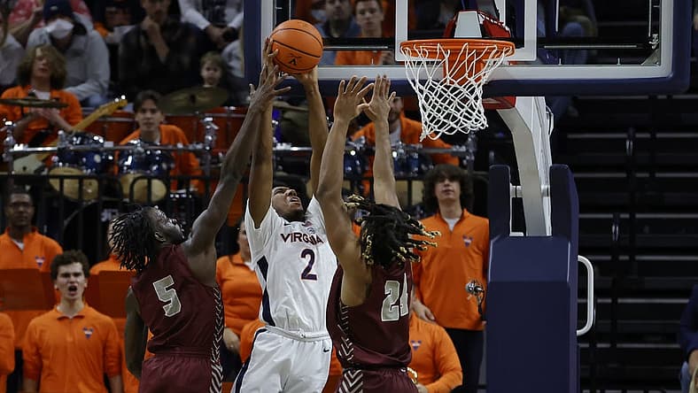 Nov 25, 2022; Charlottesville, Virginia, USA; Virginia Cavaliers guard Reece Beekman (2) attempts to dunk the bal as Maryland-Eastern Shore Hawks guard Da'Shawn Phillip (5) and Hawks forward Troy Hupstead (24) defend in the first half at John Paul Jones Arena. Mandatory Credit: Geoff Burke-USA TODAY Sports