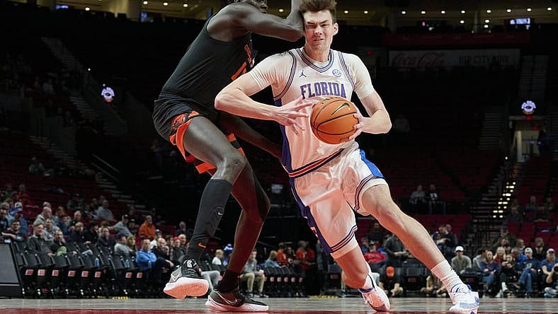 Nov 25, 2022; Portland, Oregon, USA; Florida Gators forward Colin Castleton (12) drives to the basket during the first half against Oregon State Beavers center Chol Marial (15) at Veterans Memorial Coliseum. Mandatory Credit: Troy Wayrynen-USA TODAY Sports