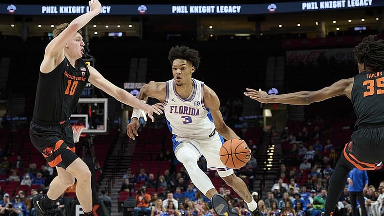 Nov 25, 2022; Portland, Oregon, USA;  Florida Gators forward Alex Fudge (3) drives past Oregon State Beavers forward Tyler Bilodeau (10) during the first half at Veterans Memorial Coliseum. Mandatory Credit: Troy Wayrynen-USA TODAY Sports