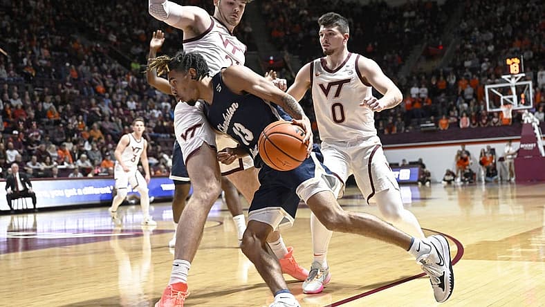 Nov 25, 2022; Blacksburg, Virginia, USA; Charleston Southern Buccaneers guard Tahlik Chavez (13) dribbles the ball defended by Virginia Tech Hokies forward Grant Basile (21) in the first half at Cassell Coliseum. Mandatory Credit: Lee Luther Jr.-USA TODAY Sports