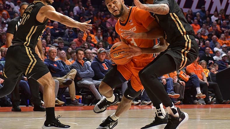 Nov 25, 2022; Champaign, Illinois, USA; Illinois Fighting Illini guard Jayden Epps (3) drives the ball between Lindenwood Lions guard Chris Childs (30) and Lindenwood Lions forward Cam Burell (5) during the first half at State Farm Center. Mandatory Credit: Ron Johnson-USA TODAY Sports