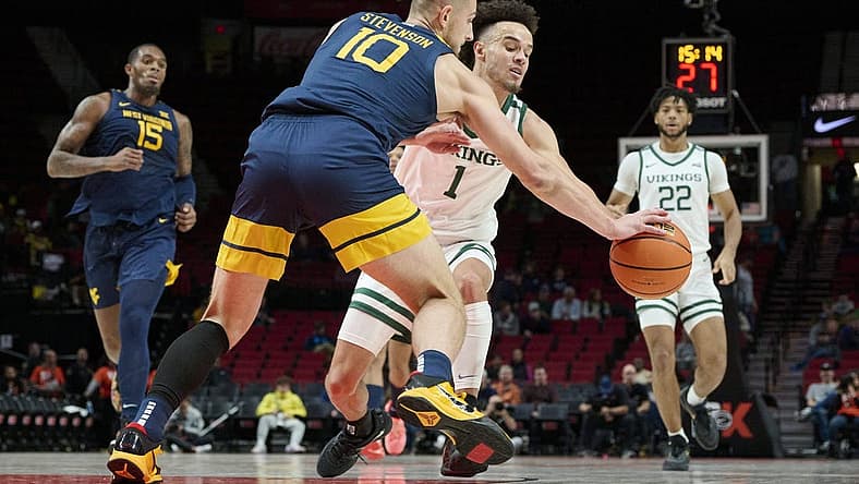Nov 25, 2022; Portland, Oregon, USA; West Virginia Mountaineers guard Erik Stevenson (10) steals the basketball away from Portland State Vikings guard Cameron Parker (1) during the first half at Moda Center. Mandatory Credit: Troy Wayrynen-USA TODAY Sports