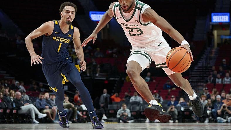 Nov 25, 2022; Portland, Oregon, USA; Portland State Vikings guard Jorell Saterfield (23) drives to the basket past West Virginia Mountaineers forward Emmitt Matthews Jr. (1) during the first half at Moda Center. Mandatory Credit: Troy Wayrynen-USA TODAY Sports
