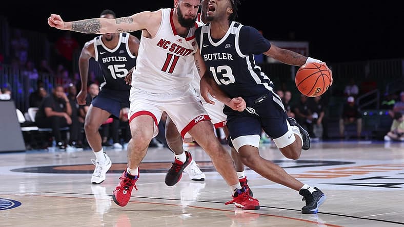Nov 25, 2022; Paradise Island, BAHAMAS; Butler Bulldogs guard Jayden Taylor (13) drives to the basket as North Carolina State Wolfpack forward Dusan Mahorcic (11) defends during the second half at Imperial Arena. Mandatory Credit: Kevin Jairaj-USA TODAY Sports