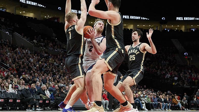 Nov 25, 2022; Portland, Oregon, USA; Gonzaga Bulldogs forward Drew Timme (2) is triple teamed by Purdue Boilermakers forward Caleb Furst (1), center Zach Edey (15) and guard Ethan Morton (25) during the first half at Moda Center. Mandatory Credit: Troy Wayrynen-USA TODAY Sports