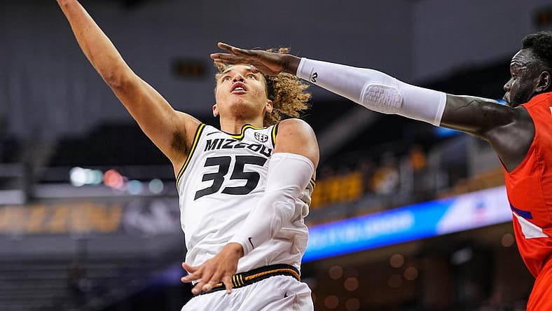 Nov 26, 2022; Columbia, Missouri, USA; Missouri Tigers forward Noah Carter (35) shoots as Houston Christian Huskies center Bonke Maring (4) defends during the second half at Mizzou Arena. Mandatory Credit: Jay Biggerstaff-USA TODAY Sports