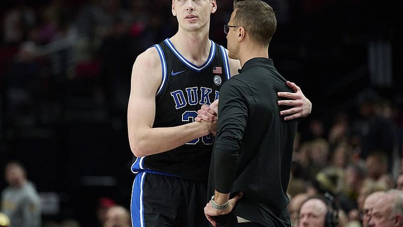 Nov 27, 2022; Portland, Oregon, USA; Duke Blue Devils center Kyle Filipowski (30) shakes hand with head coach Jon Scheyer after fouling out of the game during the second half against the Purdue Boilermakers at Moda Center. Purdue won the Phil Knight Legacy Championship game 75-56. Mandatory Credit: Troy Wayrynen-USA TODAY Sports