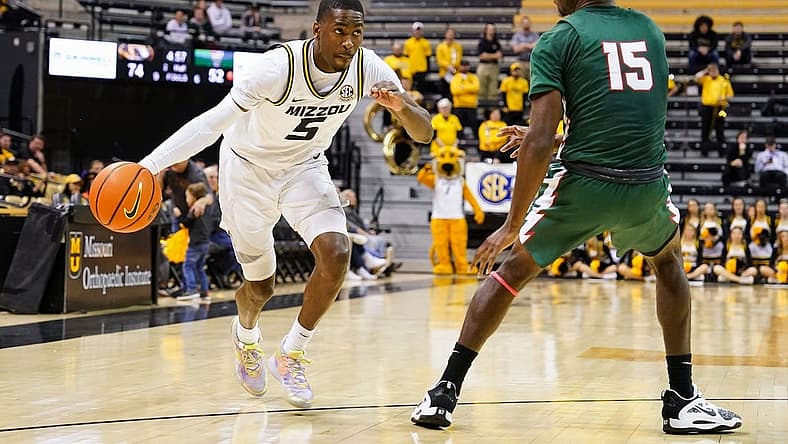 Nov 20, 2022; Columbia, Missouri, USA; Missouri Tigers guard D'Moi Hodge (5) drives against Mississippi Valley State Delta Devils forward Alvin Stredic (15) during the second half at Mizzou Arena. Mandatory Credit: Jay Biggerstaff-USA TODAY Sports