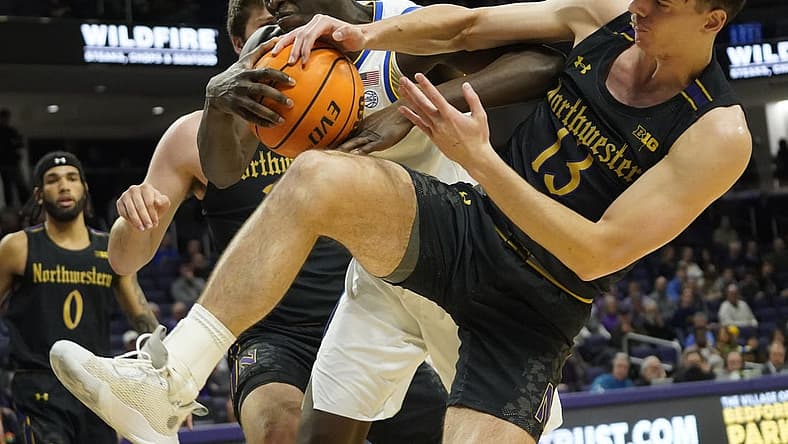 Nov 28, 2022; Evanston, Illinois, USA; Northwestern Wildcats guard Brooks Barnhizer (13) fights for the ball against Pittsburgh Panthers center Federiko Federiko (33) during the first half at Welsh-Ryan Arena. Mandatory Credit: David Banks-USA TODAY Sports