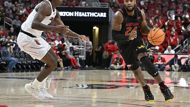 Nov 29, 2022; Louisville, Kentucky, USA; Maryland Terrapins forward Donta Scott (24) dribbles against Louisville Cardinals guard Mike James (1) during the first half at KFC Yum! Center. Mandatory Credit: Jamie Rhodes-USA TODAY Sports