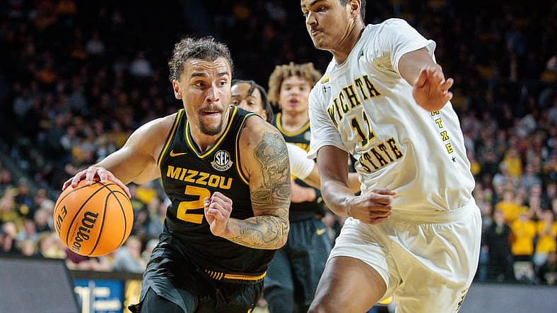 Nov 29, 2022; Wichita, Kansas, USA; Missouri Tigers guard Tre Gomillion (2) drives to the basket around Wichita State Shockers forward Kenny Pohto (11) during the first half at Charles Koch Arena. Mandatory Credit: William Purnell-USA TODAY Sports