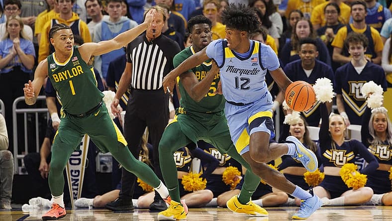 Nov 29, 2022; Milwaukee, Wisconsin, USA; Marquette Golden Eagles forward Olivier-Maxence Prosper (12) drives fore the basket against Baylor Bears forward Josh Ojianwuna (15) during the first half at Fiserv Forum. Mandatory Credit: Jeff Hanisch-USA TODAY Sports