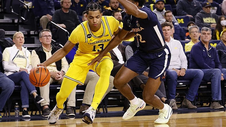 Nov 29, 2022; Ann Arbor, Michigan, USA; Michigan Wolverines guard Jett Howard (13) dribbles defended by Virginia Cavaliers guard Reece Beekman (2) in the first half at Crisler Center. Mandatory Credit: Rick Osentoski-USA TODAY Sports
