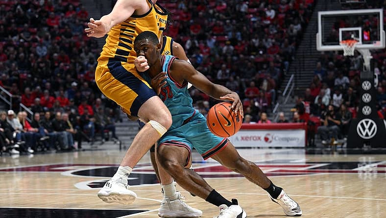 Nov 29, 2022; San Diego, California, USA; San Diego State Aztecs guard Lamont Butler (5) collides with UC Irvine Anteaters forward Dean Keeler (31) during the first half at Viejas Arena. Mandatory Credit: Orlando Ramirez-USA TODAY Sports