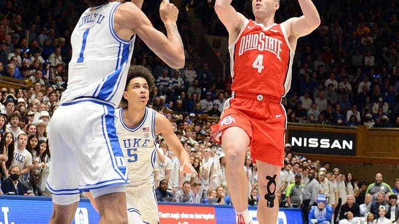 Nov 30, 2022; Durham, North Carolina, USA; Ohio State Buckeyes guard Sean McNeil (4) shooots over Duke Blue Devils center Dereck Lively (1) during the first half at Cameron Indoor Stadium. Mandatory Credit: Rob Kinnan-USA TODAY Sports