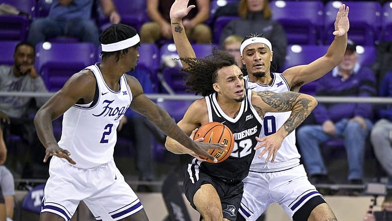Nov 30, 2022; Fort Worth, Texas, USA; TCU Horned Frogs forward Emanuel Miller (2) and guard Micah Peavy (0) guards Providence Friars guard Devin Carter (22) during the first half at Ed and Rae Schollmaier Arena. Mandatory Credit: Jerome Miron-USA TODAY Sports
