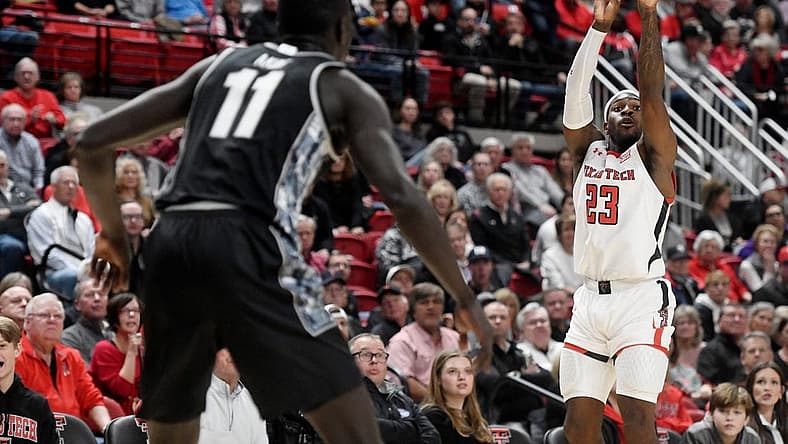 Texas Tech's guard De'Vion Harmon (23), right, shoots the ball against Georgetown in the Big East-Big 12 Battle basketball game, Wednesday, Nov. 30, 2022, at United Supermarkets Arena.