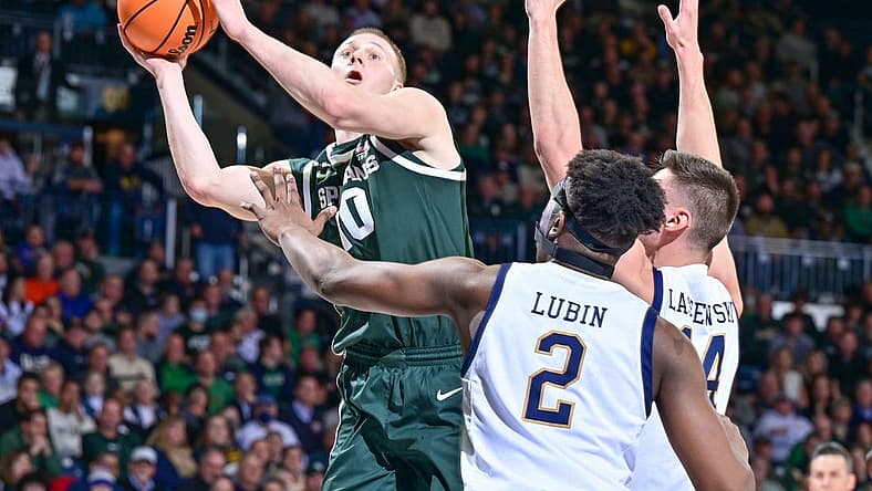 Nov 30, 2022; South Bend, Indiana, USA; Michigan State Spartans forward Joey Hauser (10) goes up for a shot as Notre Dame Fighting Irish forward Ven-Allen Lubin (2) and forward Nate Laszewski (14) defend in the first half at the Purcell Pavilion. Mandatory Credit: Matt Cashore-USA TODAY Sports