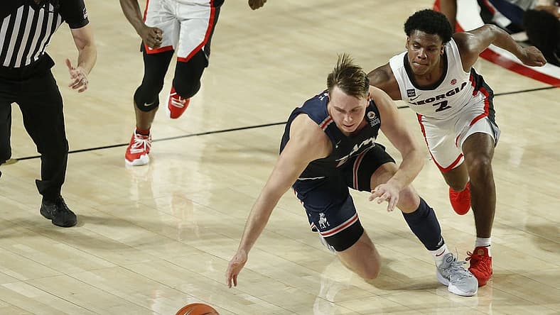 Dec 12, 2020; Athens, GA, USA; Samford forward Logan Dye (22) and Georgia's Sahvir Wheeler (2) compete for the ball during an NCAA basketball game between Georgia and Samford in Athens, Ga., on Saturday, Dec. 12, 2020. Mandatory Credit: Joshua L. Jones-USA TODAY NETWORK