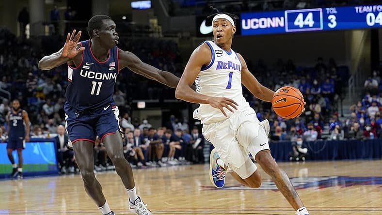 Jan 29, 2022; Chicago, Illinois, USA; DePaul Blue Demons forward Javan Johnson (1) dribbles the ball against Connecticut Huskies forward Akok Akok (11) during the second half at Wintrust Arena. Mandatory Credit: Mike Dinovo-USA TODAY Sports
