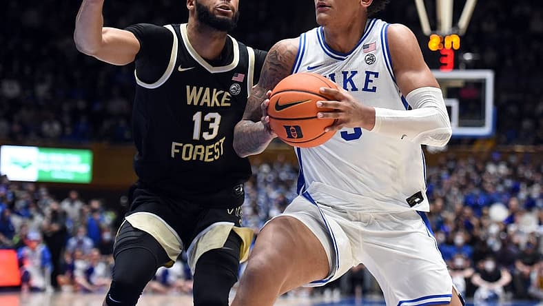 Feb 15, 2022; Durham, North Carolina, USA; Duke Blue Devils forward Paolo Banchero (5) moves to the basket as Wake Forest Demon Deacons forward Dallas Walton (13) defends during the second half at Cameron Indoor Stadium.  The Blue Devils won 76-74. Mandatory Credit: Rob Kinnan-USA TODAY Sports