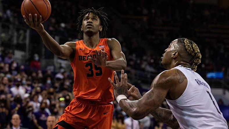 Mar 5, 2022; Seattle, Washington, USA; Oregon State Beavers forward Glenn Taylor Jr. (35) shoots the ball against Washington Huskies forward Nate Roberts (1) at Alaska Airlines Arena at Hec Edmundson Pavilion. Mandatory Credit: Stephen Brashear-USA TODAY Sports