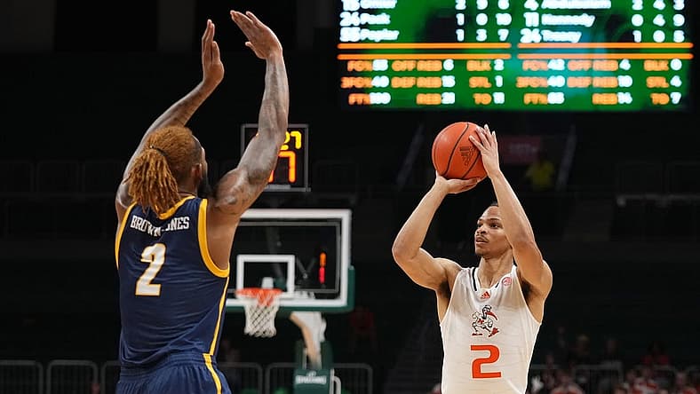 Nov 11, 2022; Coral Gables, Florida, USA; Miami Hurricanes guard Isaiah Wong (2) attempts a three point shot against the UNC Greensboro Spartans during the second half at Watsco Center. Mandatory Credit: Jasen Vinlove-USA TODAY Sports