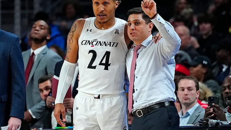 Cincinnati Bearcats guard Jeremiah Davenport (24) takes notes from head coach Wes Miller in the first half of the NCAA basketball game between the Cincinnati Bearcats and the Eastern Kentucky Colonels at Fifth Third Arena in Cincinnati on Sunday, Nov. 13, 2022.
Eastern Kentucky Colonels At Cincinnati Bearcats Basketball