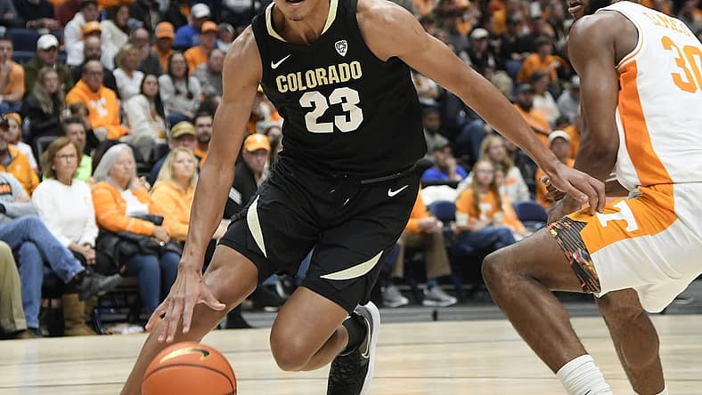 Nov 13, 2022; Nashville, Tennessee, USA;  Colorado Buffaloes forward Tristan da Silva (23) dribbles past Tennessee Volunteers guard Josiah-Jordan James (30) during the second half at Bridgestone Arena. Mandatory Credit: Steve Roberts-USA TODAY Sports