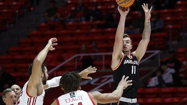 Nov 14, 2022; Salt Lake City, Utah, USA; Idaho State Bengals guard Brock Mackenzie (11) shoots over Utah Utes guard Wilguens Jr. Exacte (11) in the first half at Jon M. Huntsman Center. Mandatory Credit: Jeffrey Swinger-USA TODAY Sports