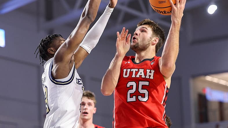 Nov 21, 2022; Fort Myers, Florida, USA; Utah Utes guard Rollie Worster (25) drives tot the basket defended by Georgia Tech Yellow Jackets guard Miles Kelly (13) in the first half during the Fort Myers Tip-off at Suncoast Credit Union Arena. Mandatory Credit: Nathan Ray Seebeck-USA TODAY Sports