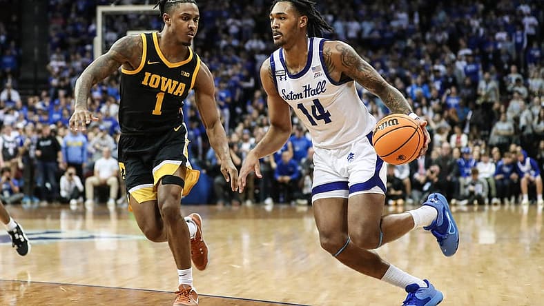 Nov 16, 2022; Newark, New Jersey, USA; Seton Hall Pirates guard Dre Davis (14) and Iowa Hawkeyes guard Ahron Ulis (1) at Prudential Center. Mandatory Credit: Wendell Cruz-USA TODAY Sports