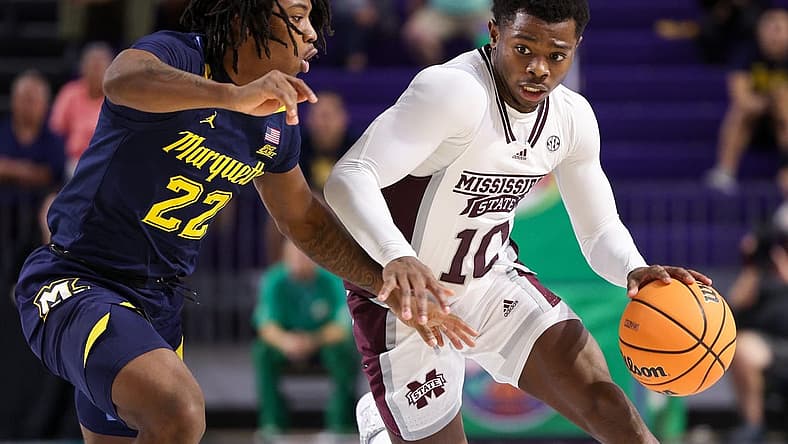 Nov 21, 2022; Fort Myers, Florida, USA; Mississippi State Bulldogs guard Dashawn Davis (10) cripples past Marquette Golden Eagles guard Sean Jones (22) in the second half during the Fort Myers Tip-off at Suncoast Credit Union Arena. Mandatory Credit: Nathan Ray Seebeck-USA TODAY Sports